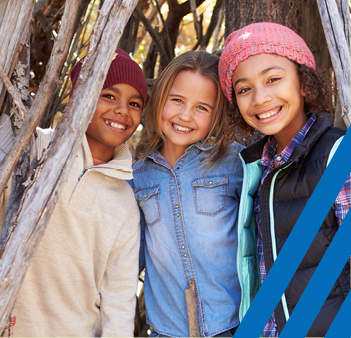 Three girls smiling and standing together