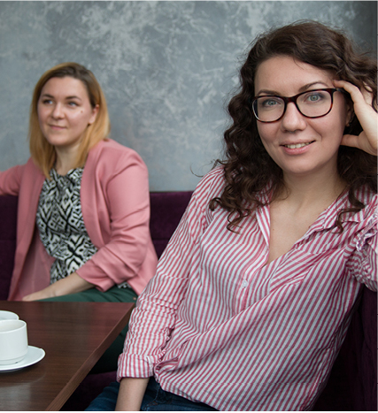 women sitting at table having conversation