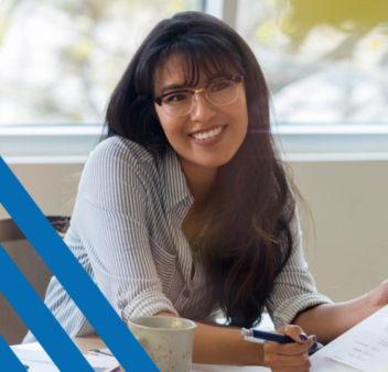 Smiling woman at desk.