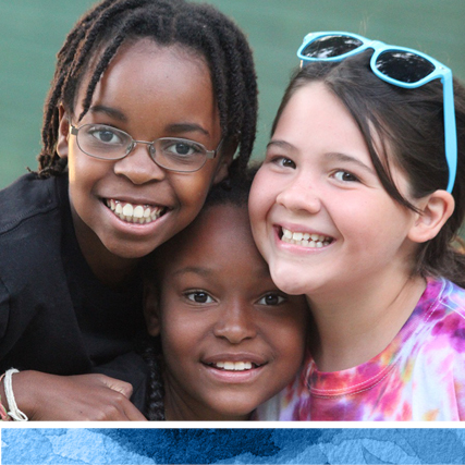 three young campers smiling