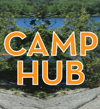 Camp Hub, group of girls on large rock with lake behind