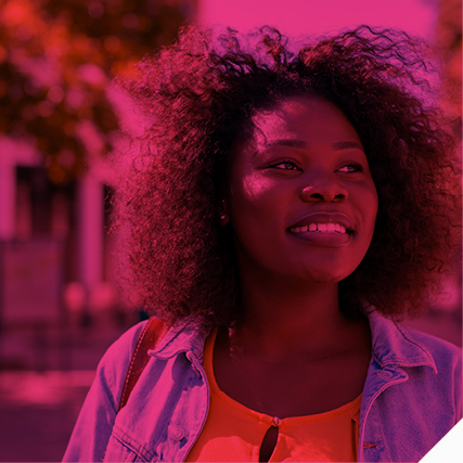 black woman smiling, staring off into the distance 