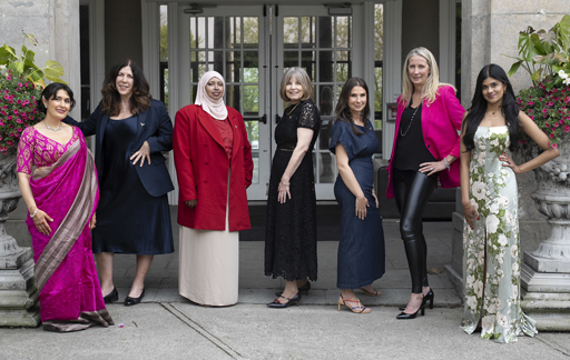 Seven women standing together in a line smiling